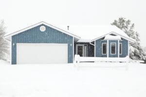 Blue home during a winter storm